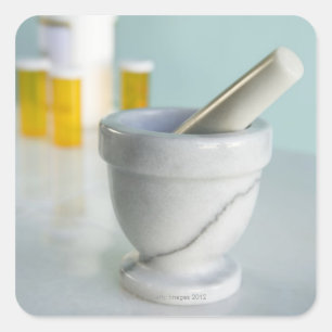 Mortar and pestle, pill bottles in background square sticker