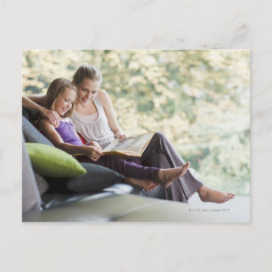 Mother and daughter reading storybook postcard