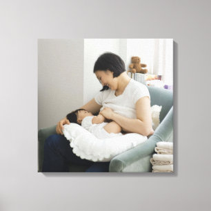 Mother breast feeding baby girl canvas print