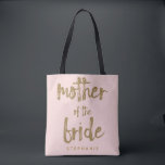 Mother of the Bride Gold Glitter Blush PInk Tote Bag<br><div class="desc">This Mother of the Bride tote bag is perfect for proud moms to tote around all their belongings at the bridal shower or the main event. This blush pink tote bag features faux gold glitter style lettering on the front. Personalise these totes with your wedding party member's name on the...</div>