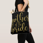 Mother of the Bride Gold Glitter Calligraphy Tote Bag<br><div class="desc">An elegant cutting edge design,  features the text "Mother of the Bride" in a extroverted script font,  the glitter texture adds a festive and glamourous touch. You can personalise the background colour according to your needs and preferences,  please contact me if you have any special request.</div>
