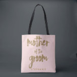 Mother of the Groom Gold Glitter Blush PInk Tote Bag<br><div class="desc">This Mother of the Groom tote bag is perfect for proud moms to tote around all their belongings at the bridal shower or the main event. This blush pink tote bag features faux gold glitter style lettering on the front. Personalise these totes with your wedding party member's name on the...</div>