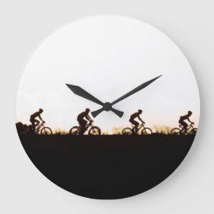 Mountain Bike Riders Make Their Way Over The Dam Large Clock
