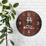 Mountain Home Family Name Large Clock<br><div class="desc">Fun,  personalised family name and monogram design.  Makes the perfect gift for a housewarming,  wedding,  or any occasion!  Wintery snowy mountain peaks and pine trees on a deep,  rich faux maple wood panel.</div>