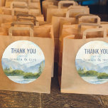 Mountain Lake Watercolor Wedding Thank You Classic Round Sticker<br><div class="desc">Mountain Lake Watercolor wedding thank you stickers with bride and groom's names. Scenic watercolor wedding favour stickers in shades of dusty blue and green. The lakeside scene features mountains, greenery and pine trees, the lake and a light sky. If you would like matching products, please browse my Mountain Lake collection....</div>