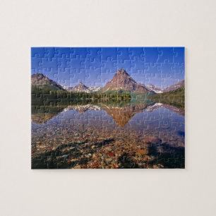 Mountains reflect into calm Two Medicine Lake in Jigsaw Puzzle