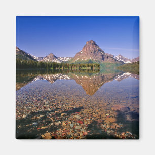 Mountains reflect into calm Two Medicine Lake in Magnet