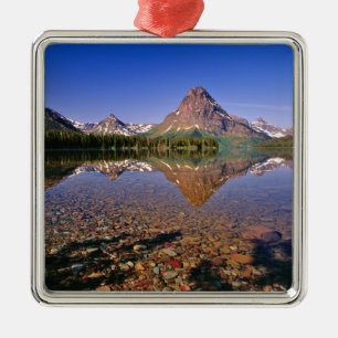 Mountains reflect into calm Two Medicine Lake in Metal Tree Decoration