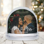 Mr and Mrs White Script Wedding Photo Snowglobe<br><div class="desc">This romantic wedding snow globe features your favourite photo with "Mr and Mrs" in beautiful white calligraphy script and your last name overlaid on the image. The back displays a second wedding photo for a stunning two-sided keepsake. Nestled in falling snow, this makes a heartfelt gift for newlyweds or a...</div>
