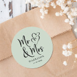 Mr Mrs Sage Wedding Classic Round Sticker<br><div class="desc">A chic sage green sticker for your wedding correspondence and party favours featuring "Mr & Mrs" in an elegant script and an illustration of two hearts joined together. Add your name and wedding date.</div>