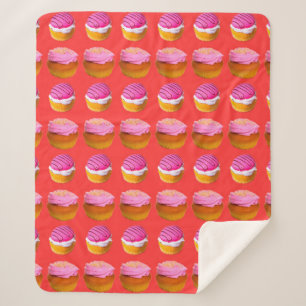 Muffins, cupcakes with white and pink cream on a r sherpa blanket