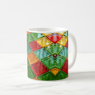 Mug decorated with multicolored diamonds.