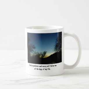 Mug with Scripture and sunset framed in trees.