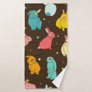 Multi-coloured, different rabbits, hares on a dark bath towel