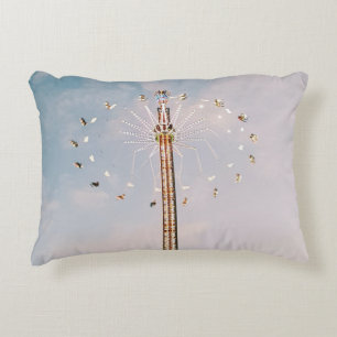 Multicolored amusement park ride under white cloud decorative cushion