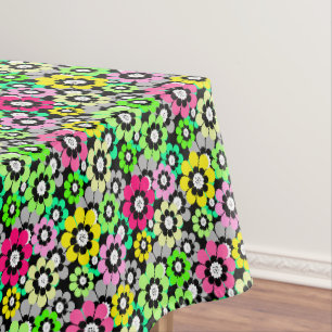 Multicolored paper cut flowers on black background tablecloth