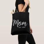 Mum Established Date White Script New Mum Gift Tote Bag<br><div class="desc">Being a mum is one of the most important jobs in the world. Show your favourite mum that you care with this custom, minimal tote bag. Simple white script calligraphy and white sans serif typography overlay a black tote bag. Personalise with the mum “established” year date when your first child...</div>