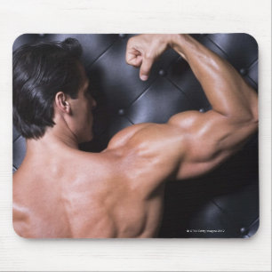 Muscular man flexing mouse mat