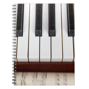 musical notes on the background of a pianoacoustic notebook