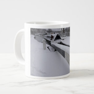 Narrowboat on the canal during a snowy day large coffee mug