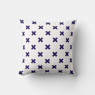 Navy blue cross stitches on white cushion