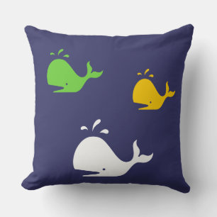 navy blue, yellow and green whales on white cushion