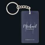 Navy Modern Script Personalised Groomsmen Key Ring<br><div class="desc">Add a personal touch to your wedding with personalised groomsmen keychain. This keychain features personalised groomsmen's name in white modern script font style and monogram in light navy blue modern script font style as background with title and wedding date in white modern sans serif font style on navy blue background....</div>