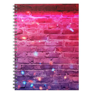 Neon light: empty brick wall. notebook