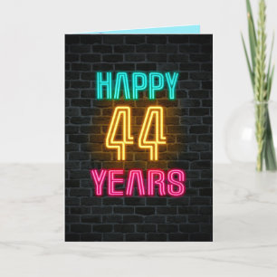 Neon sign on brick for 44th birthday card