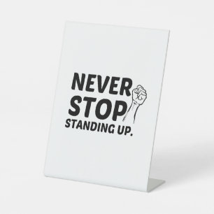 NEVER STOP STANDING UP PEDESTAL SIGN
