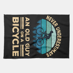 Never Underestimate An Old Guy On A Bicycle Funny  Tea Towel