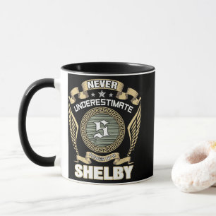 NEVER_UNDERESTIMATE_POWER_OF_A_SHELBY MUG
