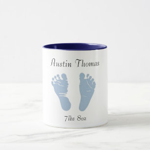 Newborn baby feet coffee cup