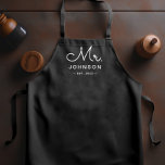 Newlywed Groom Personalised Black Apron<br><div class="desc">For the bride and groom, this black apron features "Mr." in a modern script font along with a last name and established date. This is a perfect bridal shower or wedding gift. These Mr. and Mrs. aprons are available in a variety of colours and can be also customised to match...</div>