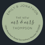 Newlyweds Return Name Address Sage Green Classic Round Sticker<br><div class="desc">A modern fully customisable typographical design with your names curved above and your return address curved below and text in the middle The New Mr and Mrs And your married name in black on a sage green background. All the text can be easily personalised. You can also change background and...</div>