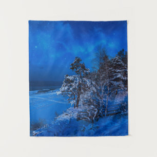 Nighttime winter scene with snow covered pines tapestry