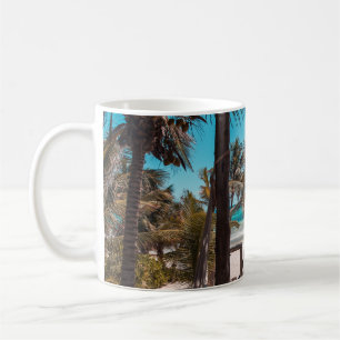 Nipa hut under coconut palm trees coffee mug