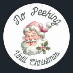 No peeking until Christmas fun pink Santa Classic Round Sticker<br><div class="desc">No peeking until Christmas featuring a smiling Santa with a pink hat.</div>