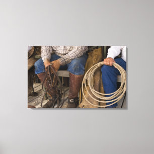 North America, USA. Cowboys relaxing and 2 Canvas Print