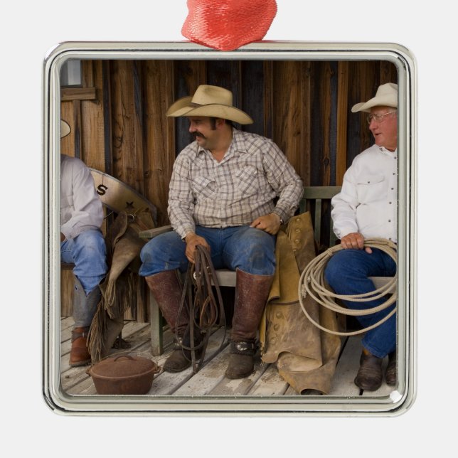 North America, USA. Cowboys relaxing and Metal Tree Decoration (Front)