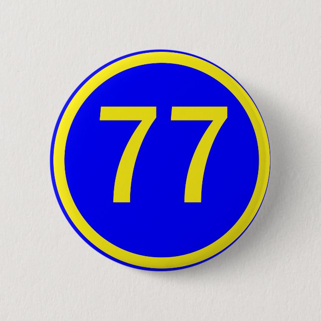 number, 77,  in a circle 6 cm round badge (Front)
