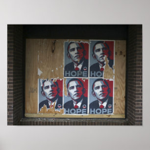 Obama signs in a boarded window of a closed