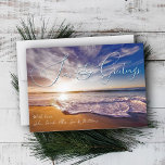 Ocean Sunrise Seas and Greetings Christmas Cards<br><div class="desc">Beach themed Christmas flat cards with ocean sunrise scene. Large, thin script at the top "Seas & Greetings" can be changed to your preferred holiday greeting - "Merry Christmas", "Happy Holidays", and "Seasons Greetings" all fit the space. The signature is aligned left at the bottom in white script over brown...</div>