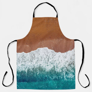Ocean wave on a sandy beach, background top view apron