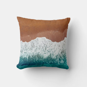 Ocean wave on a sandy beach, background top view cushion