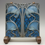 Oceanic Grace Art Nouveau Ceramic Tile<br><div class="desc">Dive into the serene beauty of the Art Nouveau style with this Oceanic Grace Ceramic Tile, which gracefully combines the flowing lines of natural seaforms with an elegant design. Shades of cerulean, navy, and sky blue evoke the tranquil depths of the ocean, while silvery grey outlines create a striking contrast,...</div>