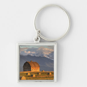 Old barn framed by hay bales and dramatic key ring