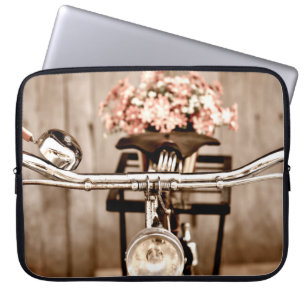 Old bicycle and flowers blur in background process laptop sleeve