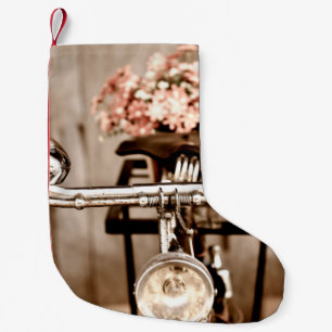 Old bicycle and flowers blur in background process small christmas stocking