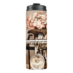 Old bicycle and flowers blur in background process thermal tumbler